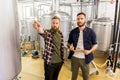 Men with clipboard at craft brewery or beer plant Royalty Free Stock Photo