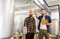 Men with clipboard at craft brewery or beer plant Royalty Free Stock Photo