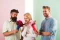 Men competitors with bouquets flowers try conquer girl. Girl likes to be in middle attention. Love triangle. Woman Royalty Free Stock Photo