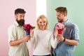 Men competitors with bouquets flowers try conquer girl. Girl smiling reject gifts. Feminism concept. Woman smiling Royalty Free Stock Photo