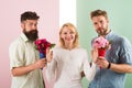 Men competitors with bouquets flowers try conquer girl. Girl smiling reject gifts. Out of relations. Feminism concept Royalty Free Stock Photo