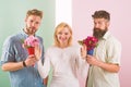 Men competitors with bouquets flowers try conquer girl. Girl smiling reject gifts. Out of relations. Girl popular Royalty Free Stock Photo