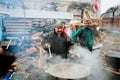 Men cook traditional soup outdoor