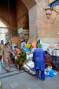 Men and coolies mill around arched entrance to Empress Market shops Saddar Karachi Pakistan