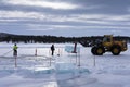 Men cut ice blocks from a frozen lake needed to build the Ice hotel in JuakkasjÃ¤rvi, Sweden