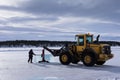 Men cut ice blocks from a frozen lake needed to build the Ice hotel in JuakkasjÃ¤rvi, Sweden