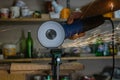 Men cuts a small metal sheet with an electric grinder