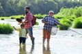 Men day. Family bonding. Fly fisherman using fly fishing rod in river. Fly fishing for trout. Grandfather and grandchild Royalty Free Stock Photo