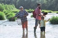 Men day. Family bonding. Fly fisherman using fly fishing rod in river. Fly fishing for trout. Grandfather and grandchild Royalty Free Stock Photo