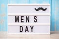 Men day text with mustache on lightbox. International Men day and Father day concept