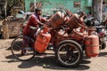 Men delivering cooking gas cylinders to customers on the streets of Colaba district, Mumbai, India