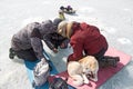 Men and dog on the winter ice fishing on the lake Baikal. Royalty Free Stock Photo