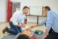 Men doing first aid with dummy