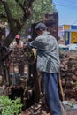 Men drawing water from a well in mahabaleshwar street.Sahyadri range of Maharashtra