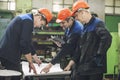 Men with drawings working in an old factory to install the equip Royalty Free Stock Photo