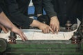 Men with drawings working in an old factory to install the equip