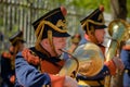 A men dressed in an old military uniform playing the trumpet in Royalty Free Stock Photo