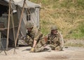 Men dressed in wartime US army soldiers uniform reenacting military maneuvers during Victory Day Europe Celebration Event