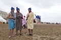 Men in dressing gowns on the beach Royalty Free Stock Photo