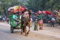 Men driving camel cart for tourists in Taj Ganj neighborhood of