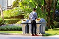 Men are dumping plastic bottles waste into trash bin recycle at sideways walk at garden public Royalty Free Stock Photo