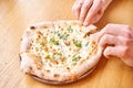 Men eats tasty pizza with Gorgonzola and pear. Baked in Traditional wood oven in Naples restaurant, Italy. Original Royalty Free Stock Photo