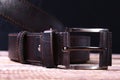 Men elegance leather belt on wooden table.