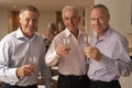 Men Enjoying Champagne At A Dinner Party