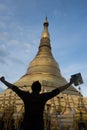 Men enjoying the view of the famous shwedagon pagoda in myanmar