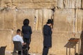 Men facing Wailing Wall while praying