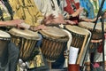 Men and famme play djembe