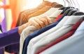 Men fashion clothes - Hanging clothes suit colorful or closet rack different coloured man suits in a closet on hangers in a store Royalty Free Stock Photo