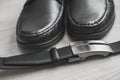 Men fashion. Men accessories. Black shoes and black belt . Still life. Business look on a wooden background Royalty Free Stock Photo