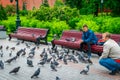 Men feed birds in Alexandrovsky Garden of The Moscow Kremlin.