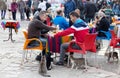 Men feeding cats on the street