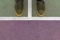 Men feet in green leather sneakers stand on the colored rubberized surface Royalty Free Stock Photo