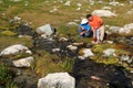 Men Filtering Water from Mountain Stream Royalty Free Stock Photo