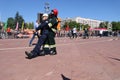 Men firefighter in fireproof suit out of danger at exercises, at fire-fighting competitions, Minsk, Belarus, 06.06.2018