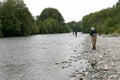 Men fishing on the banks of river