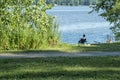 Men fishing with is dog at Andre Corbeil Park