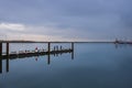 Men fishing on a pier in a early morning. Man with a fishing rod on a river Royalty Free Stock Photo