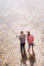 Men fishing relaxing while enjoying hobby. Successful catch. Fun and relax. Mature man with friend fishing. Nice day for Royalty Free Stock Photo