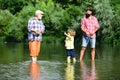 3 men fishing on river in summer time. Grandfather and grandchild. Man in different ages. Dad and son fishing at lake.