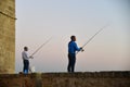 Men fishing on the wall of ancient Acre