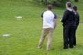 Men flying a drone in the park