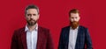 men in formalwear isolated on burgundy background with selective focus. bearded men in formalwear