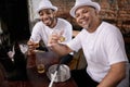 Men, friends and toast with alcohol in portrait at pub for good luck with smile, bonding or party with beer. People Royalty Free Stock Photo