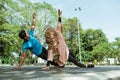 a man and a girl in a veil in gym clothes doing hand exercises together for endurance training