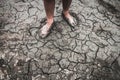 Men on ground cracked dry due to drought. Royalty Free Stock Photo
