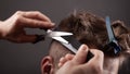 Men haircut. master cuts man with scissors close-up